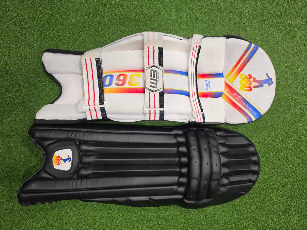 Top face view of EM 360 PLAY BURST adult white cricket batting pads on green artificial turf on Alberta.