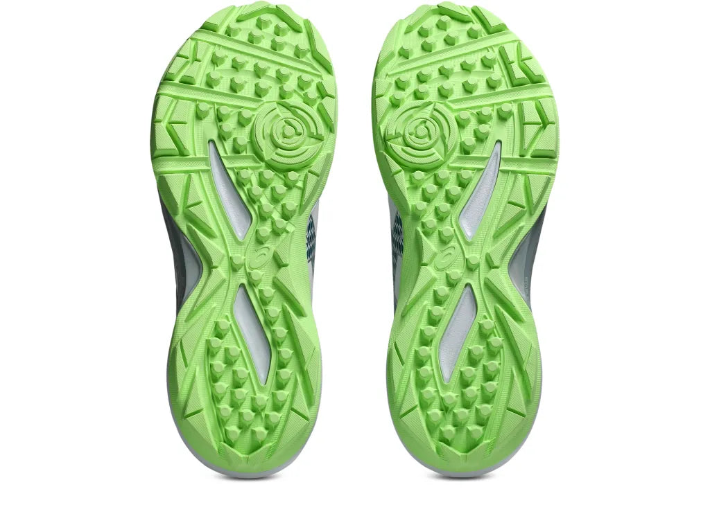 Outsole tread view of the Asics Gel-Peake 3 Rubber Cricket Shoes showcasing bright green multi-directional rubber studs