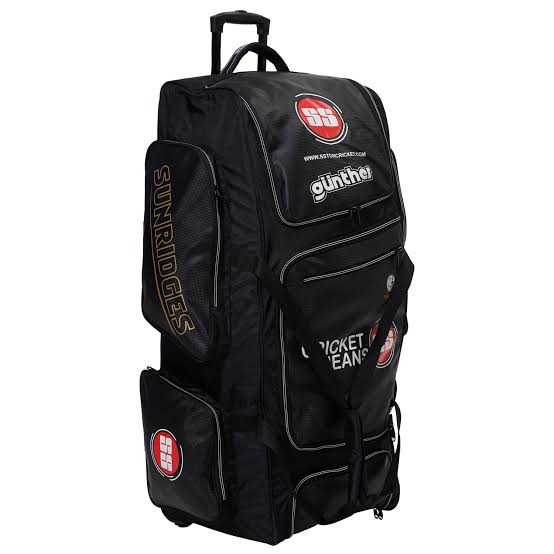 Side angle view of SS TON Gunther cricket kit bag duffle with wheels in black showing extendable trolley handle on Alberta.