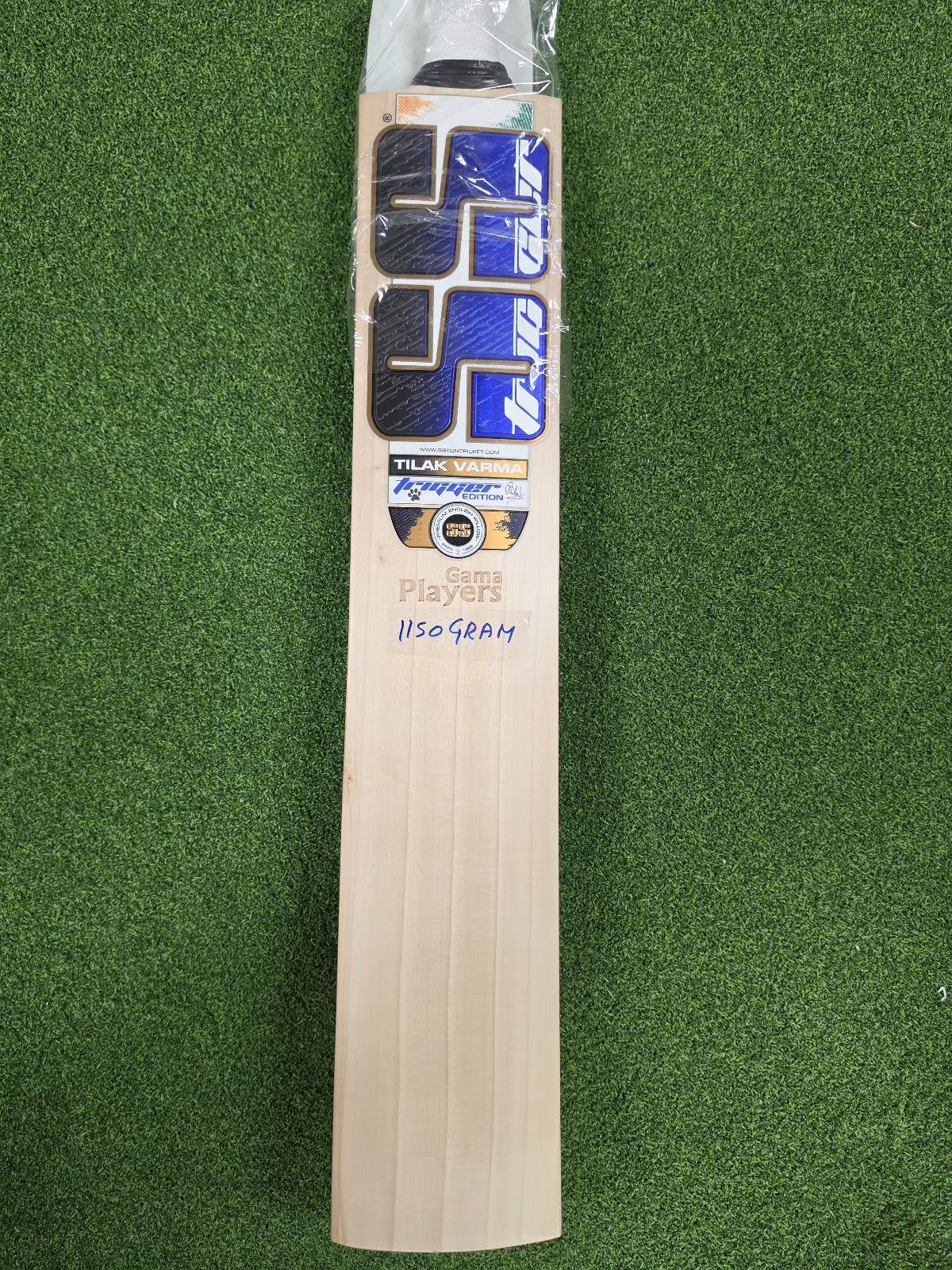 Front face view of SS Ton Gama Players Tilak Varma English Willow Cricket Bat showing 1150g weight mark on green turf at Alberta Cricket Store