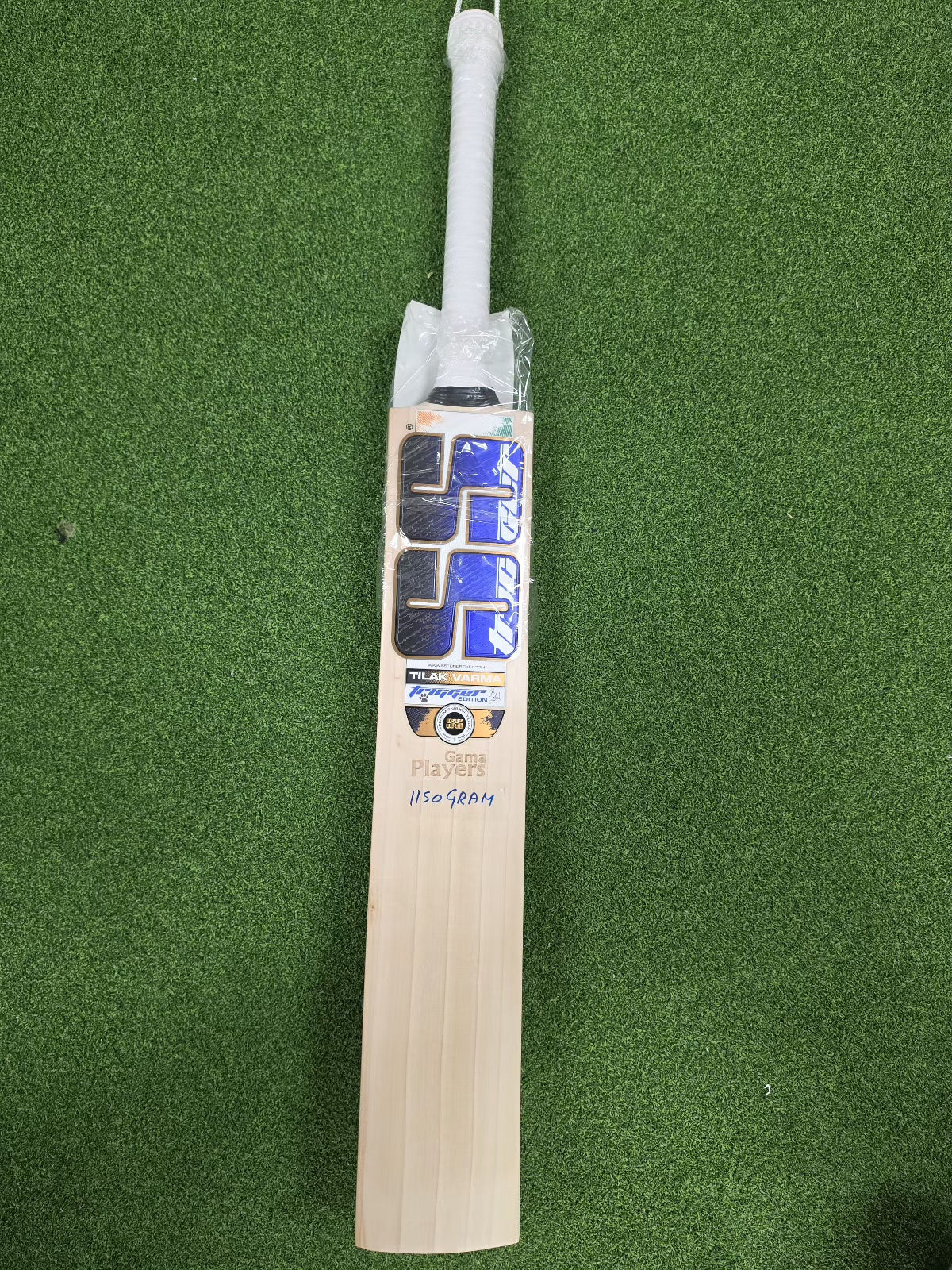 Full front view of SS Ton Gama Players Tilak Varma English Willow Cricket Bat on green turf at Alberta Cricket Store
